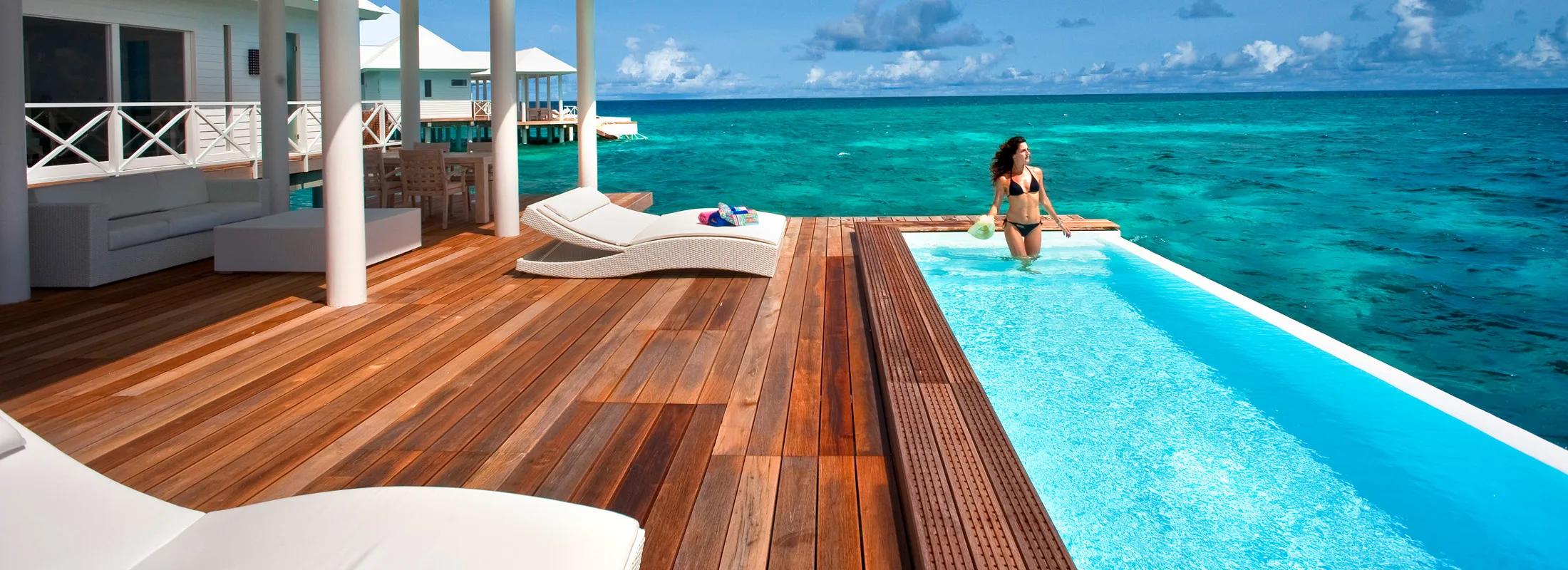 The deck and jacuzzi tub of a Jacuzzi Water Villa, positioned directly over the reef
