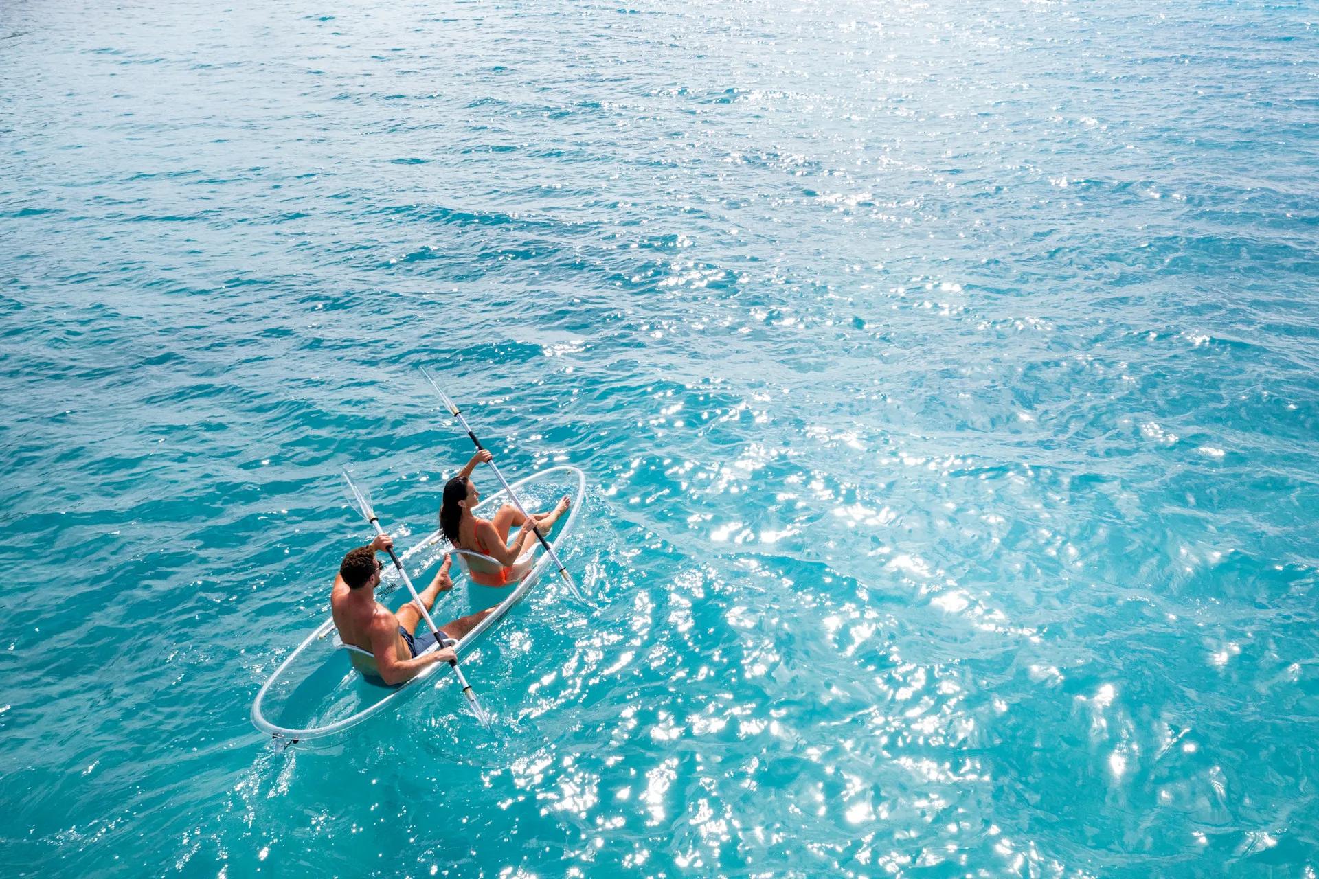 A guest glass-kayaking over the reef near the resort