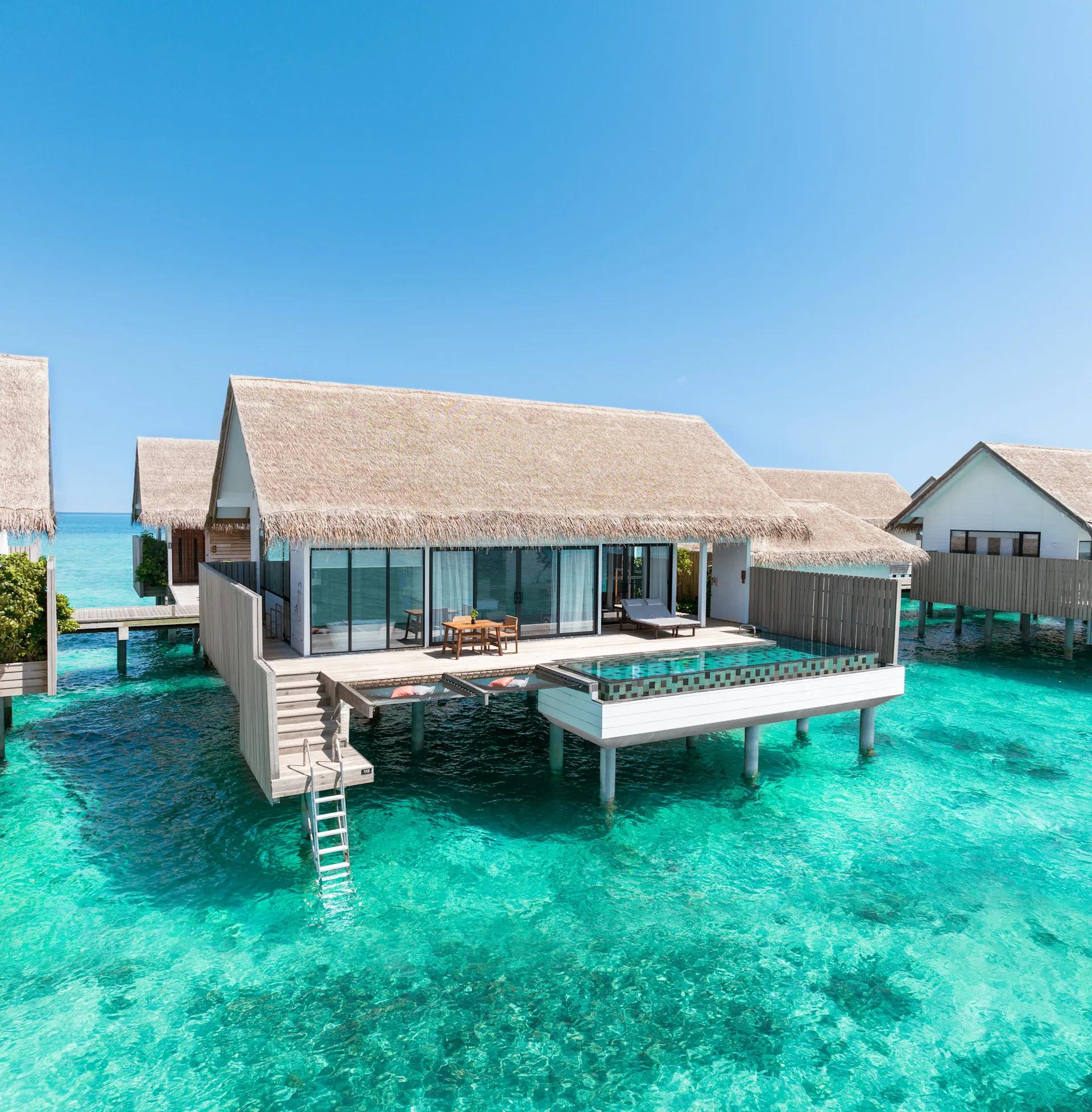 The exterior of a One Bedroom Overwater Suite with Pool, its extra living room and deck set over the lagoon
