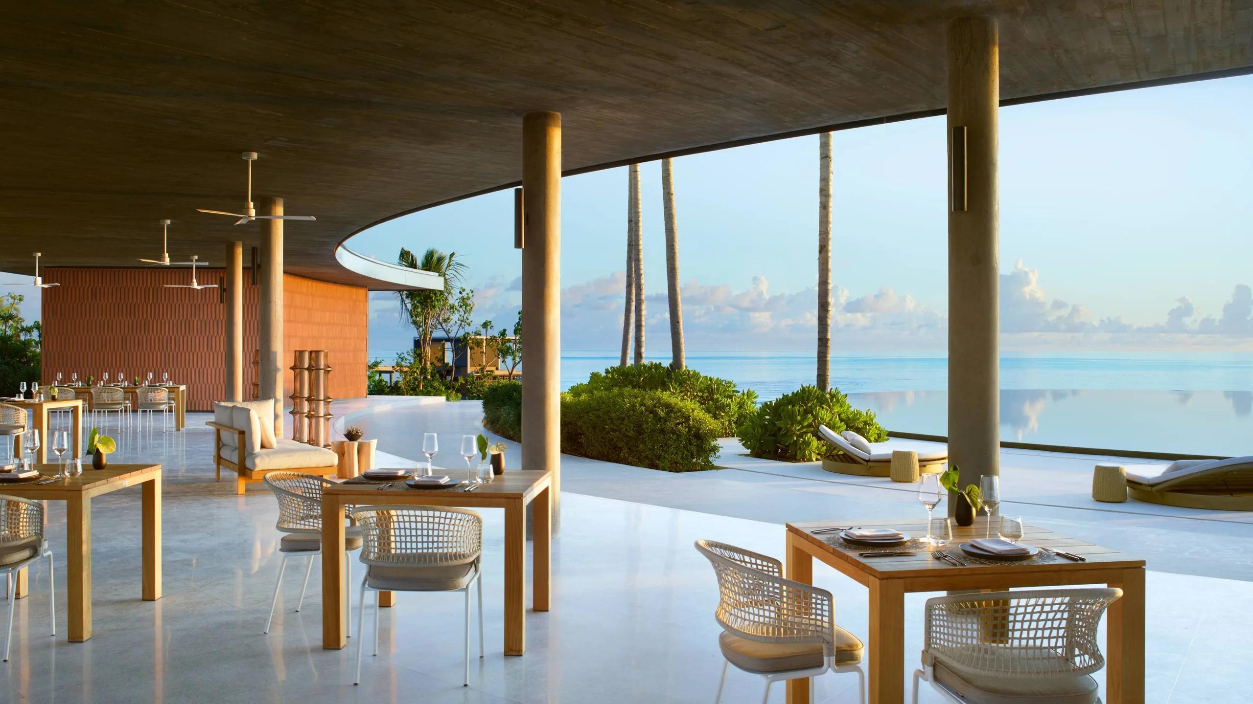 EAU Bar's terrace circling the round infinity pool by day