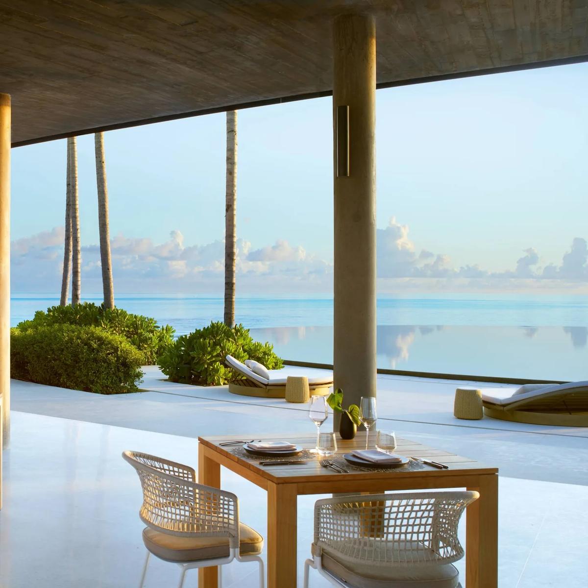 EAU Bar's terrace circling the round infinity pool by day