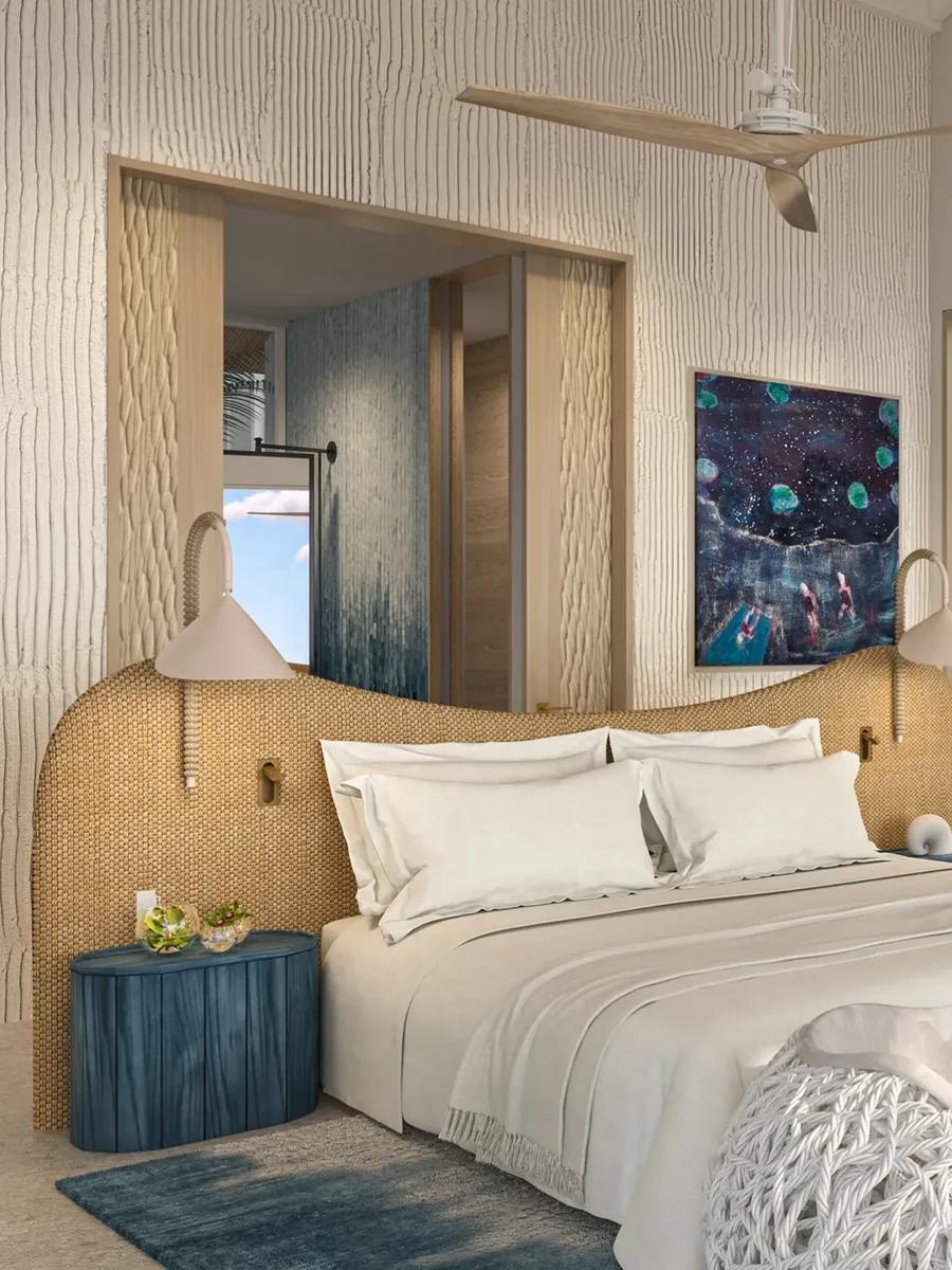 A bedroom in the Lagoon Residence at .Here, glass doors opening onto the deck with the lagoon beyond