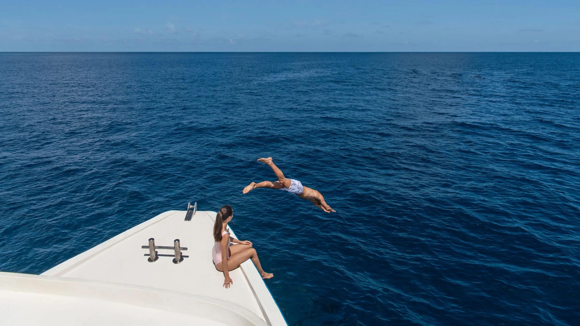 Guests swimming during Halcyon's equator-crossing voyage, one stop on its island-hopping excursions