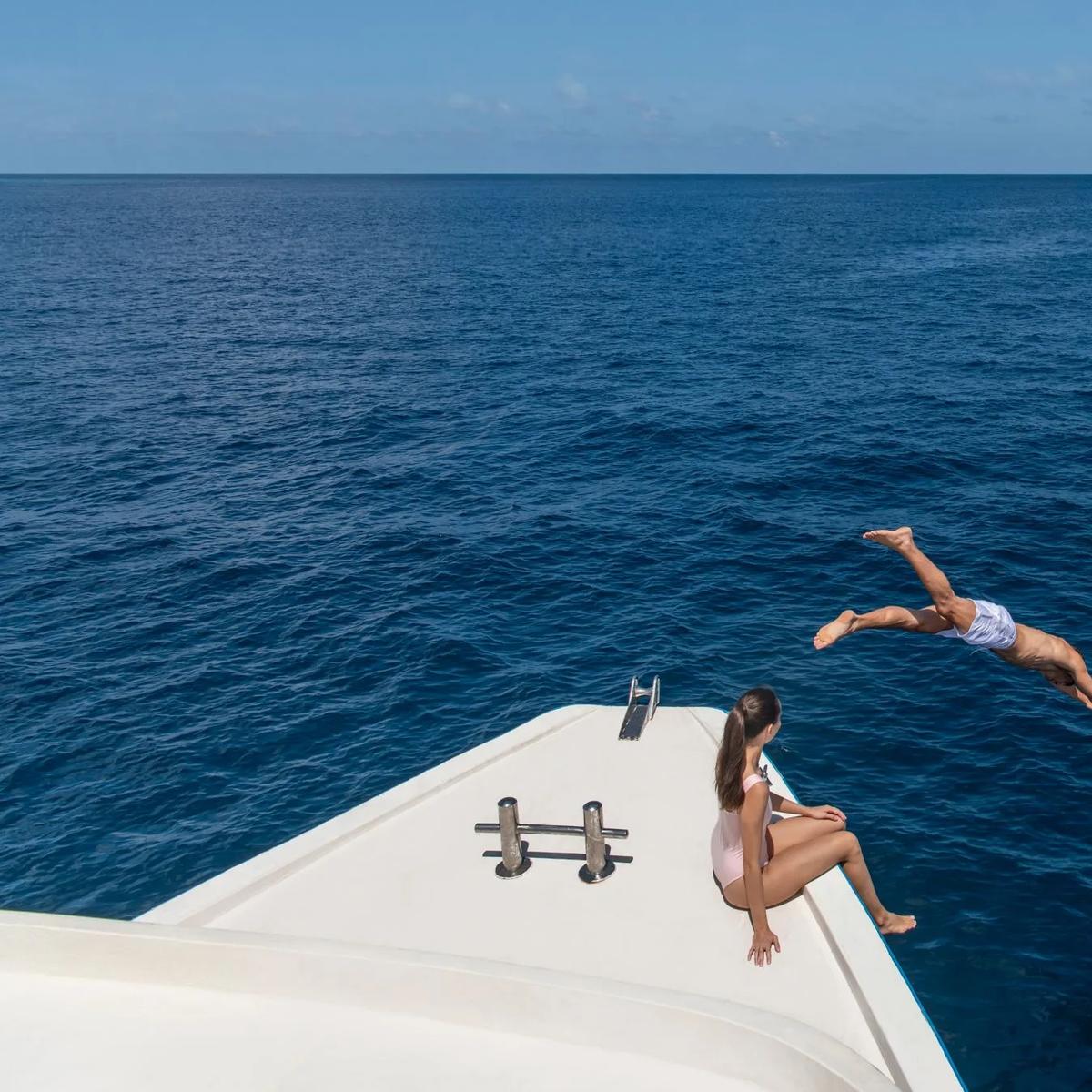 Guests swimming during Halcyon's equator-crossing voyage, one stop on its island-hopping excursions