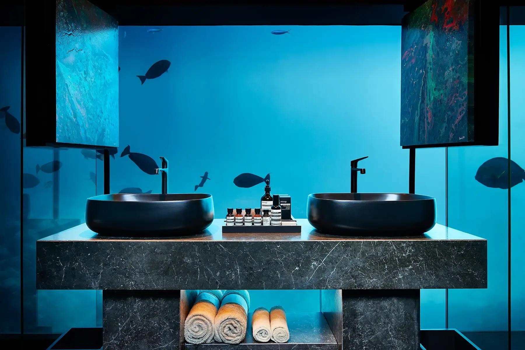 The undersea bathroom of The Muraka at Conrad Maldives Rangali, its glass walls open to the reef and passing fish
