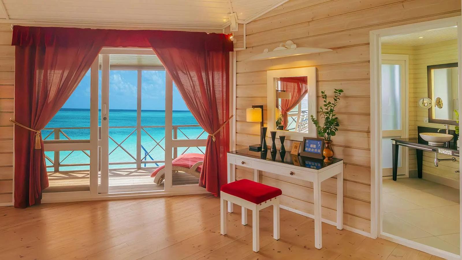View from inside the Sangu Water Villa Honeymoon Suite across the open deck to the lagoon