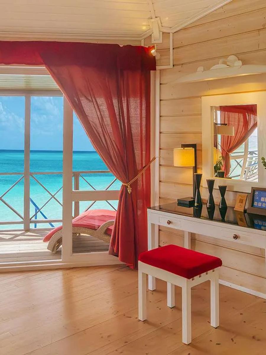 View from inside the Sangu Water Villa Honeymoon Suite across the open deck to the lagoon