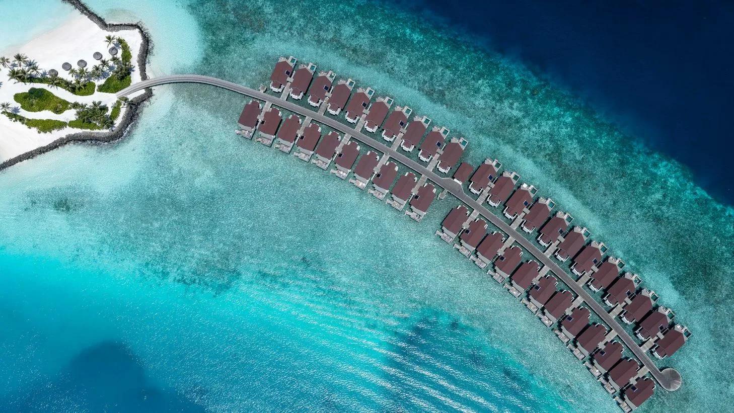 Aerial view of the overwater jetty holding OBLU SELECT Lobigili's Nest and SunNest Water Villas, reef visible on both sides