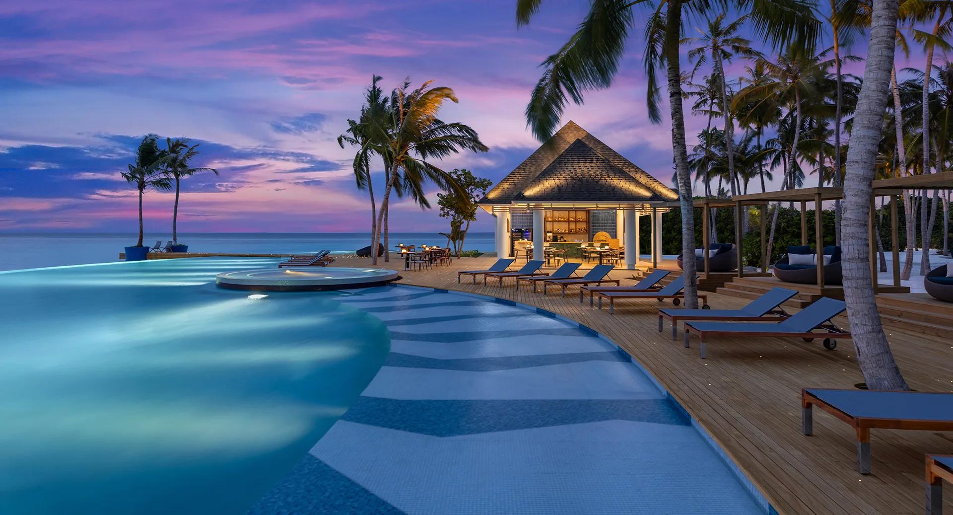 Twilight at Skipjack Poolside Bar & Restaurant — Avani+ Fares has not published a dedicated photograph of Charcoal; this evening dining scene from elsewhere on the resort stands in