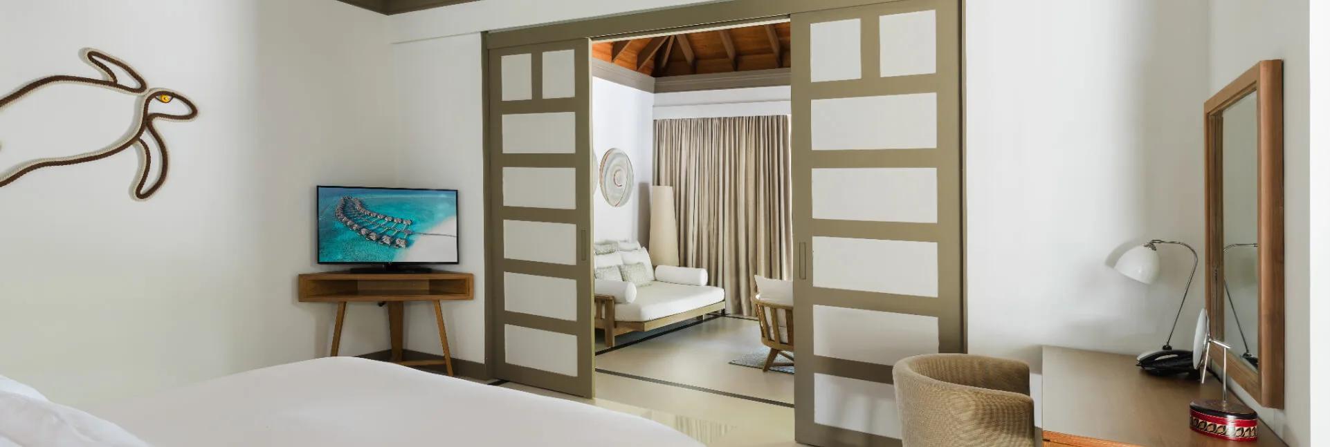 A Deluxe Beach Villa with Family Private Pool at JA Manafaru, walled garden around a family-size pool