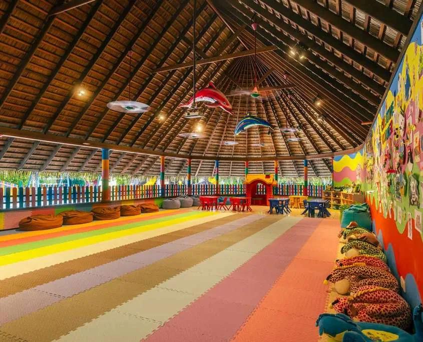 The interior of Max's Mermaids & Pirates Kids' Club, coloured play mats and hanging dolphin decorations