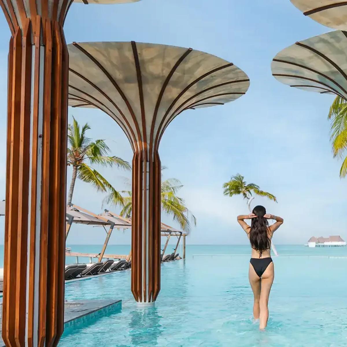 The infinity pool beside Baa, the resort's main bar, with overwater villas in the distance