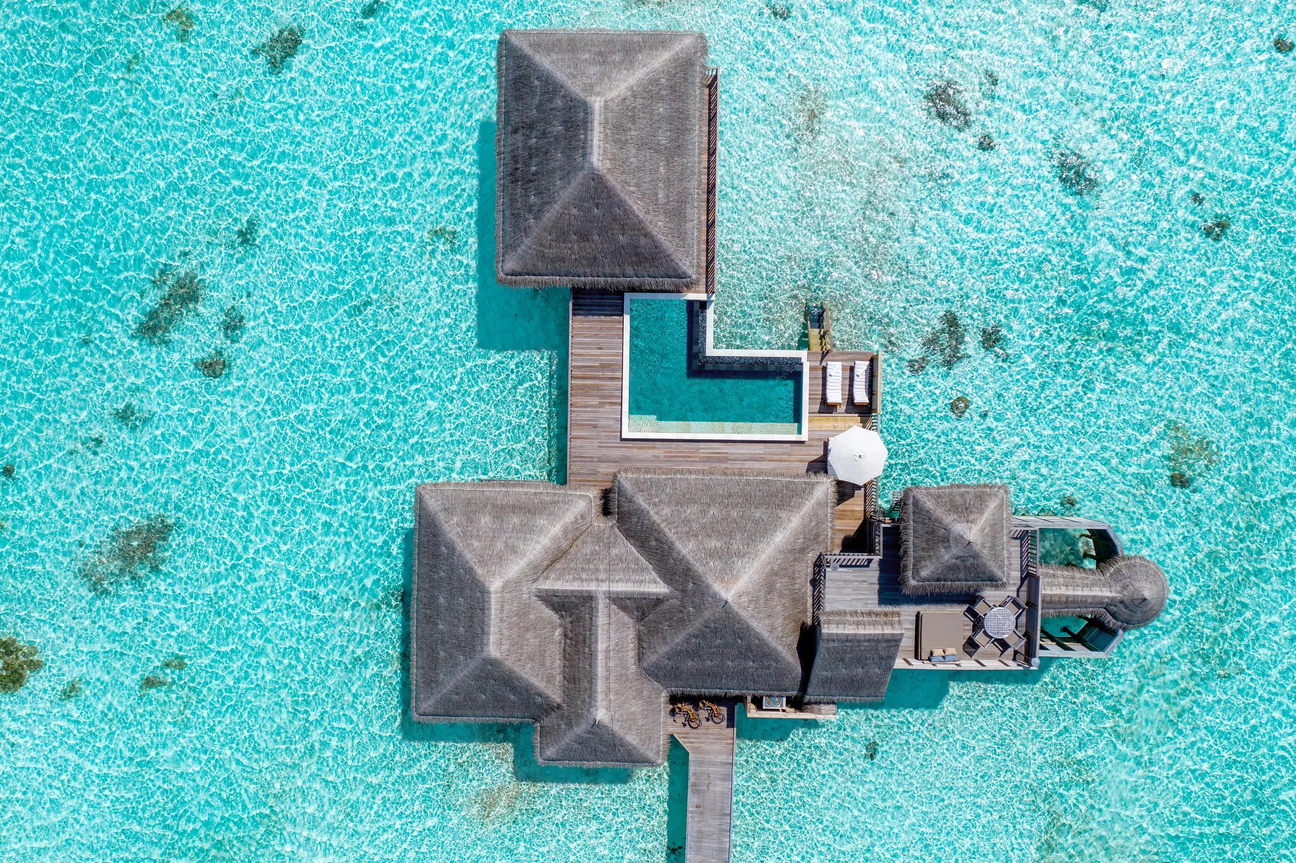 Aerial view of a Family Villa with Pool at Gili Lankanfushi, overwater villas ringing the lagoon in North Malé Atoll