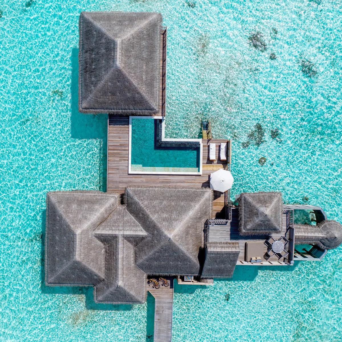 Aerial view of a Family Villa with Pool at Gili Lankanfushi, overwater villas ringing the lagoon in North Malé Atoll