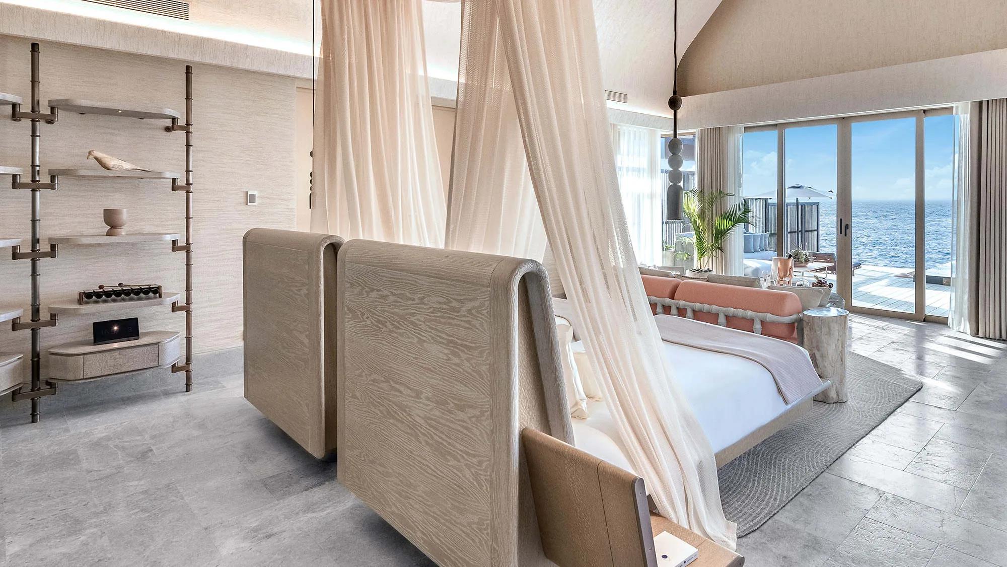 The king bedroom of an Ocean Pool Villa at Joali Being, floor-to-ceiling windows facing the Indian Ocean