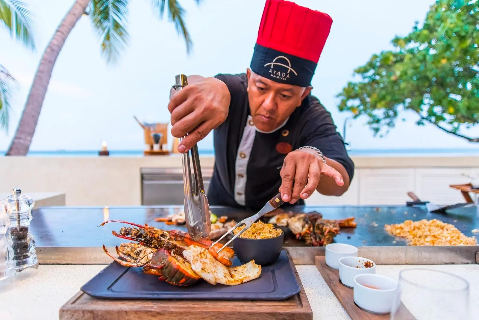 The chef working the teppanyaki grill at Mizu, plating fresh lobster