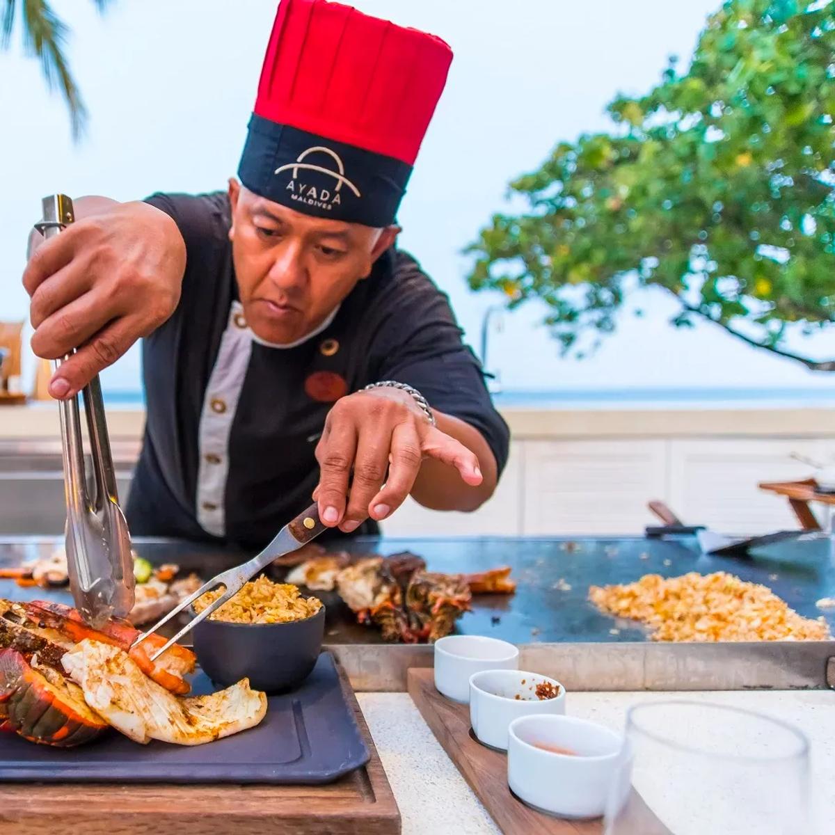 The chef working the teppanyaki grill at Mizu, plating fresh lobster