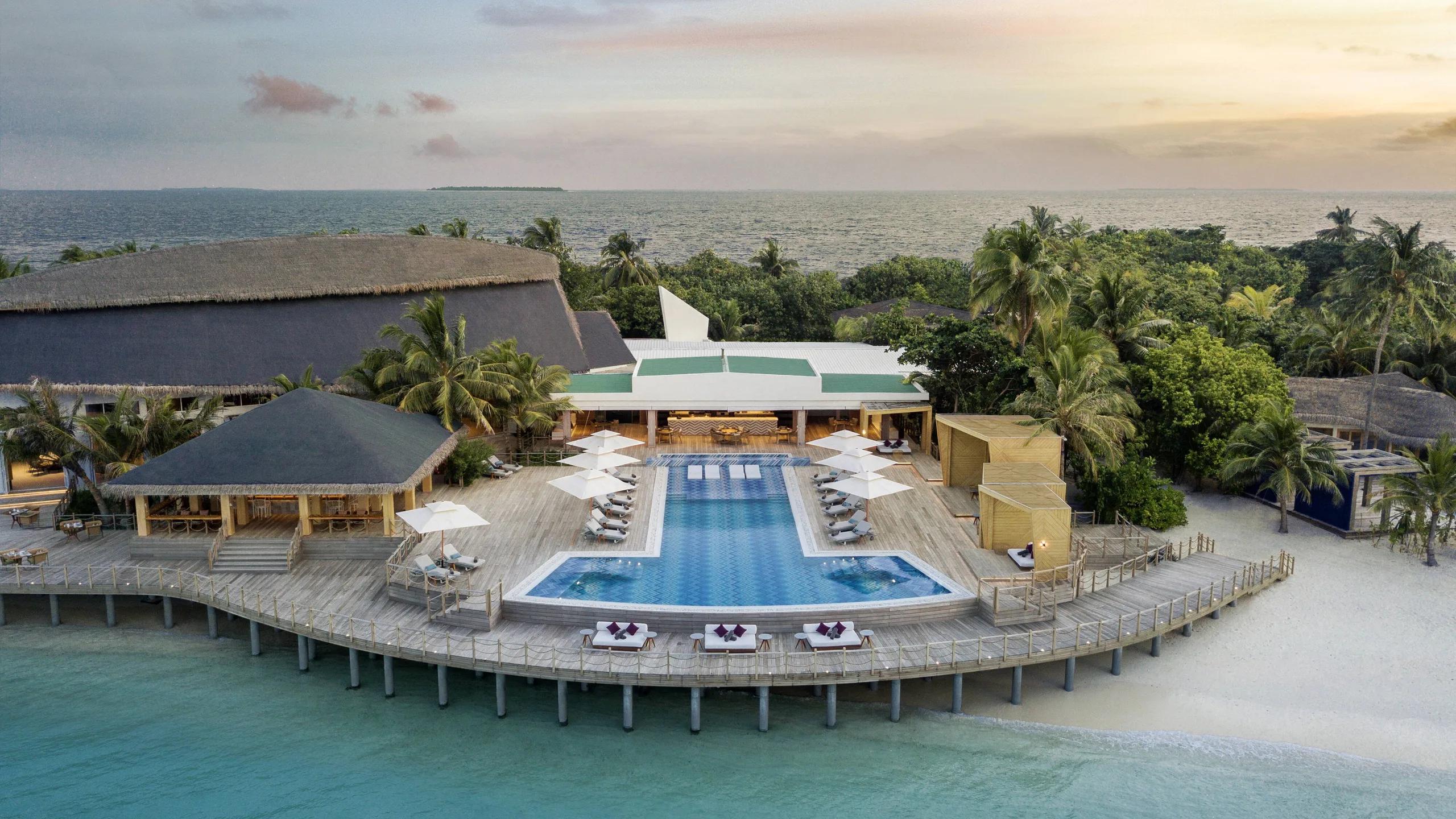 Horizon Pool and its beachfront bar pavilion, seen from above at sunset