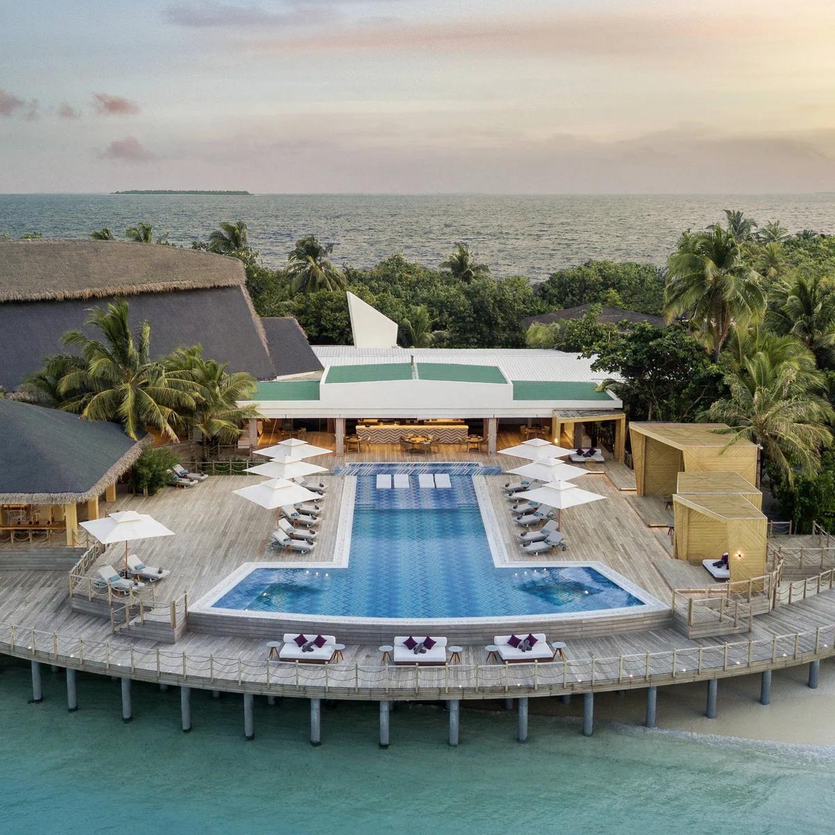 Horizon Pool and its beachfront bar pavilion, seen from above at sunset