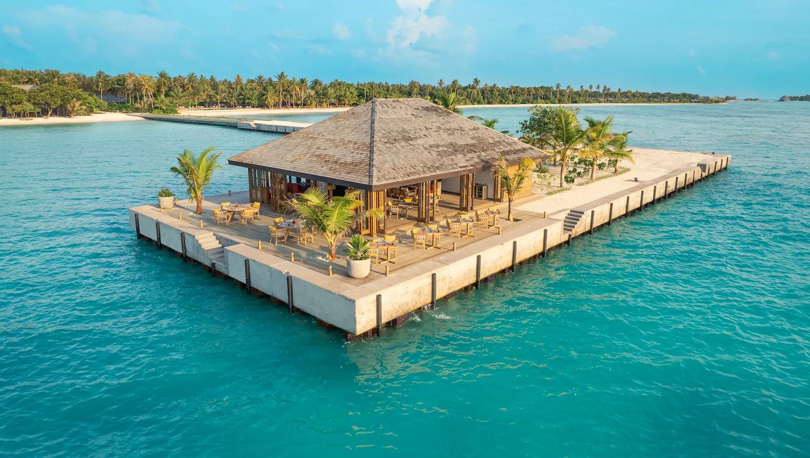 Molo Restaurant and Bar's overwater pavilion at Mabin Island, catching the light at sunset