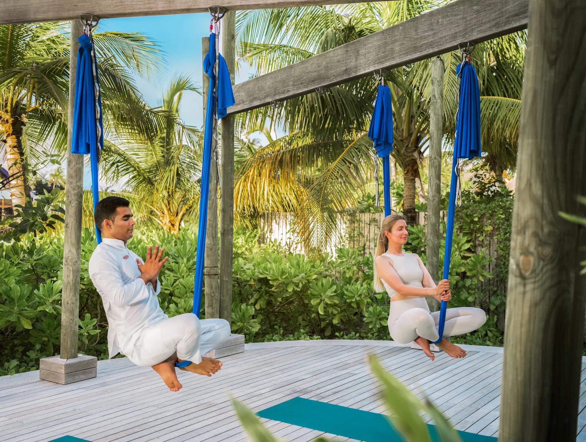 An aerial yoga session at Amingiri Spa & Hammam's open-air yoga pavilion