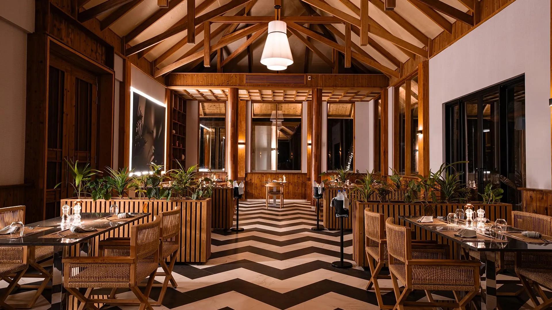 Flores' dining room with its chevron-tiled floor, set for evening service