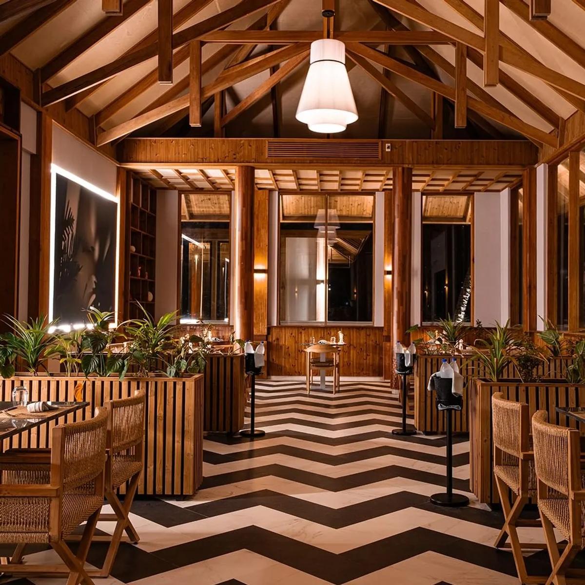 Flores' dining room with its chevron-tiled floor, set for evening service
