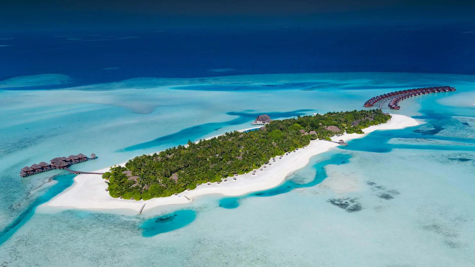 Aerial view of Anantara Dhigu Maldives Resort on Dhigufinolhu Island, South Malé Atoll, ringed by lagoon and reef