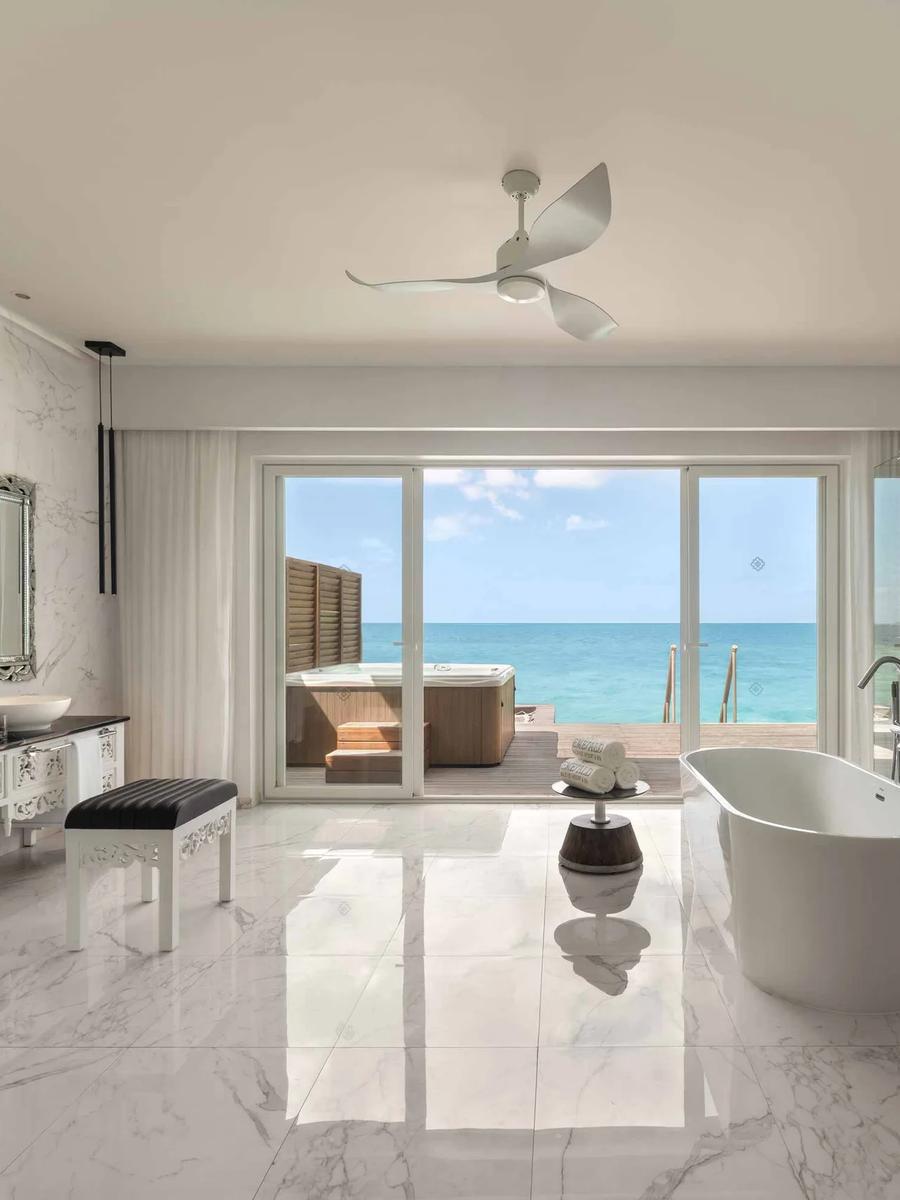 A Jacuzzi Water Villa's deck and private 2x2 m jacuzzi, over the lagoon