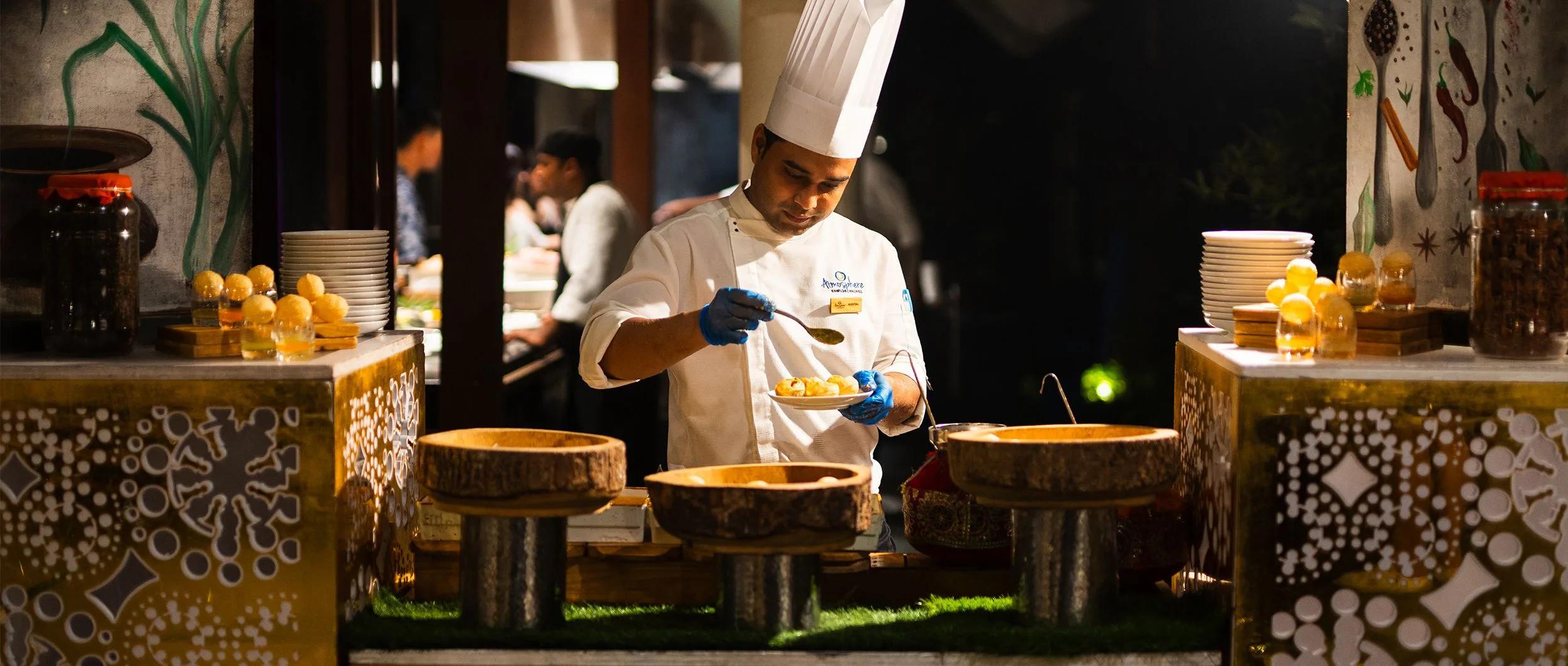 A chef plates a dish at one of The Spice's live cooking stations — reused for Ceylon Bliss, since no dedicated images exist for that venue in official site photography