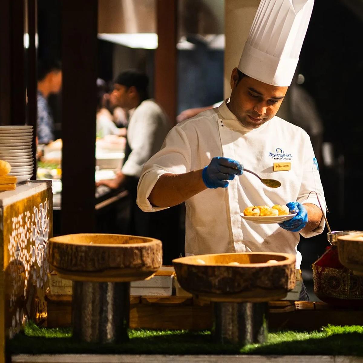A chef plates a dish at one of The Spice's live cooking stations — reused for Ceylon Bliss, since no dedicated images exist for that venue in official site photography