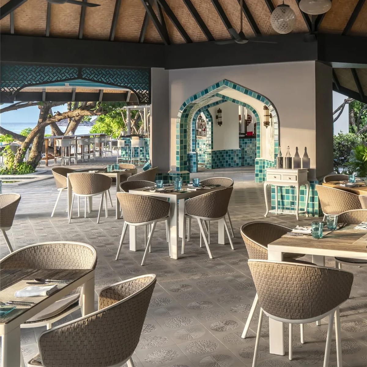 Reef Club's dining room, a coral mosaic on the wall and the pool visible through the archway