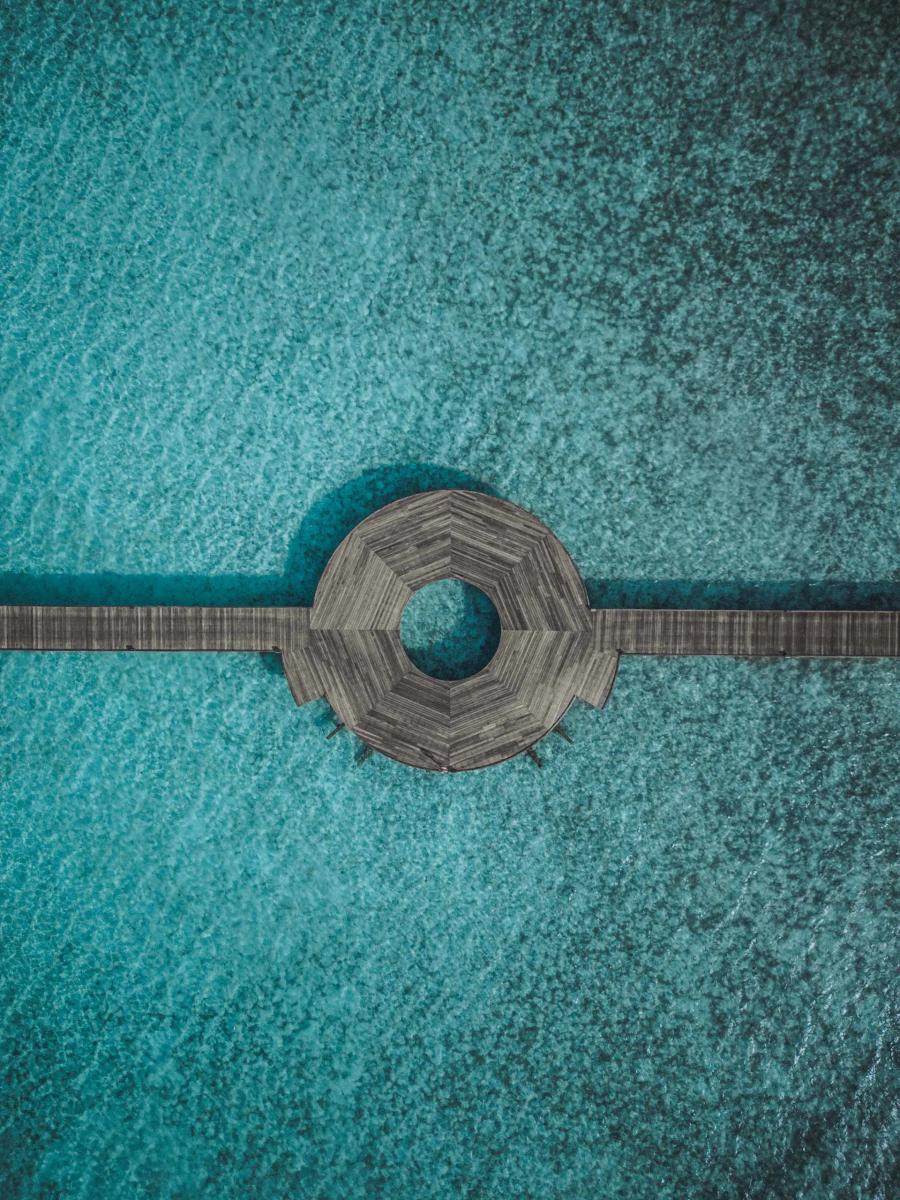 Aerial view directly above one of Diamonds Athuruga's overwater pavilions