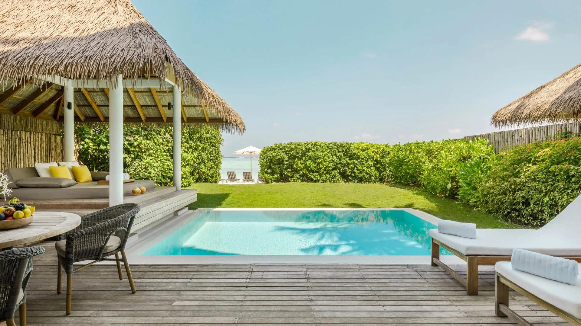 Two-Bedroom Beach House's private pool and thatched-roof lounge pavilion, set on its own lawn