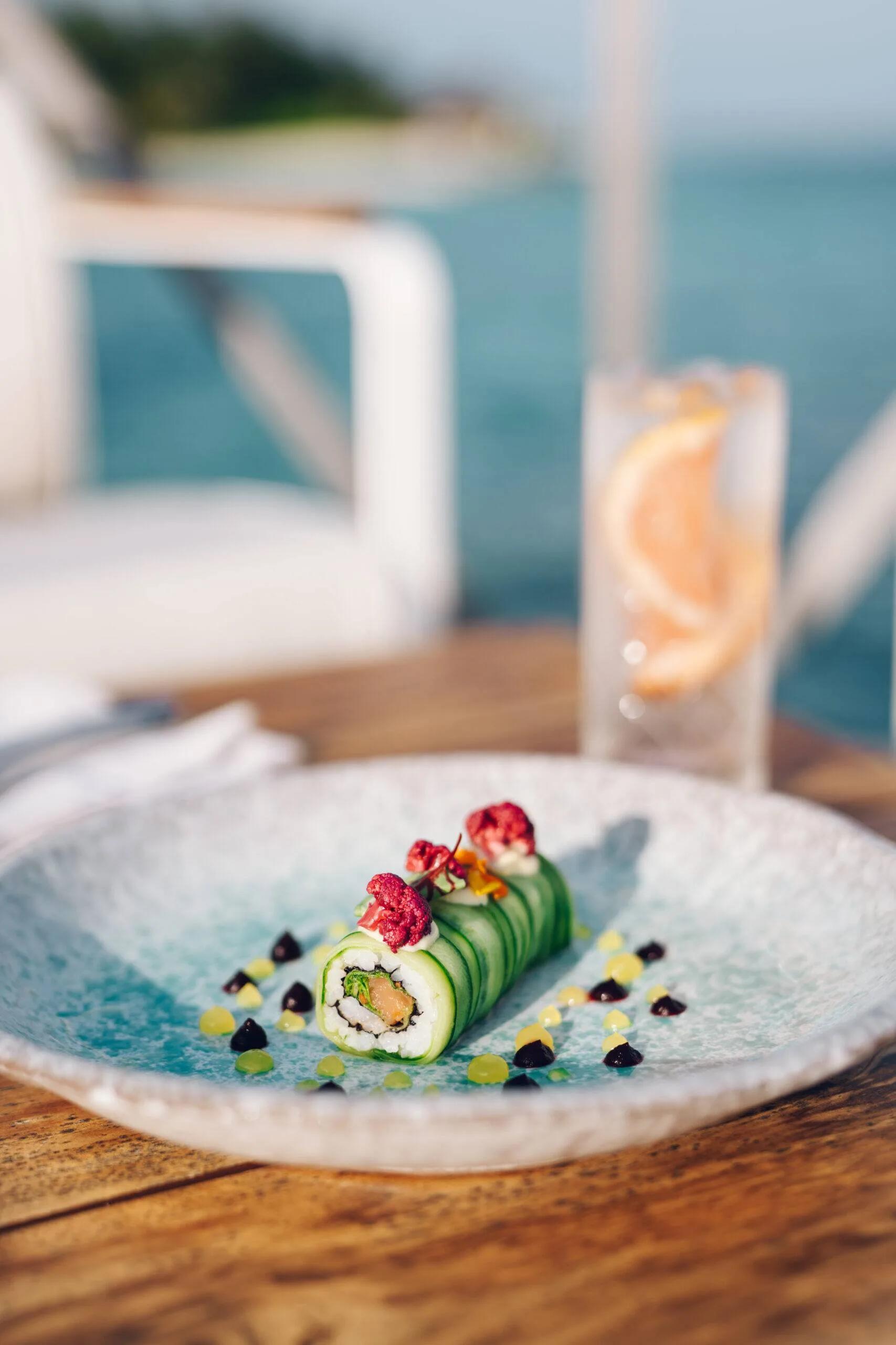 A cucumber-wrapped roll plated at Raw, Huvafen Fushi's raw and organic dining venue