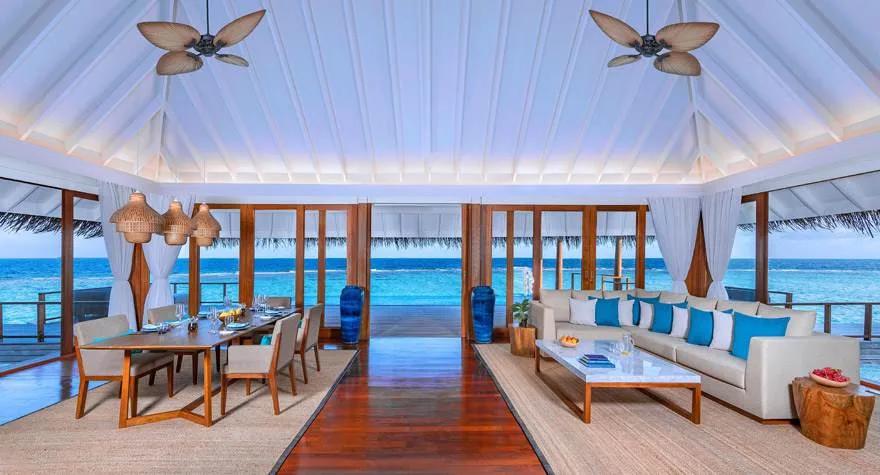 Living room of a Two Bedroom Sunset Over Water Pool Residence at Anantara Kihavah, overlooking the lagoon