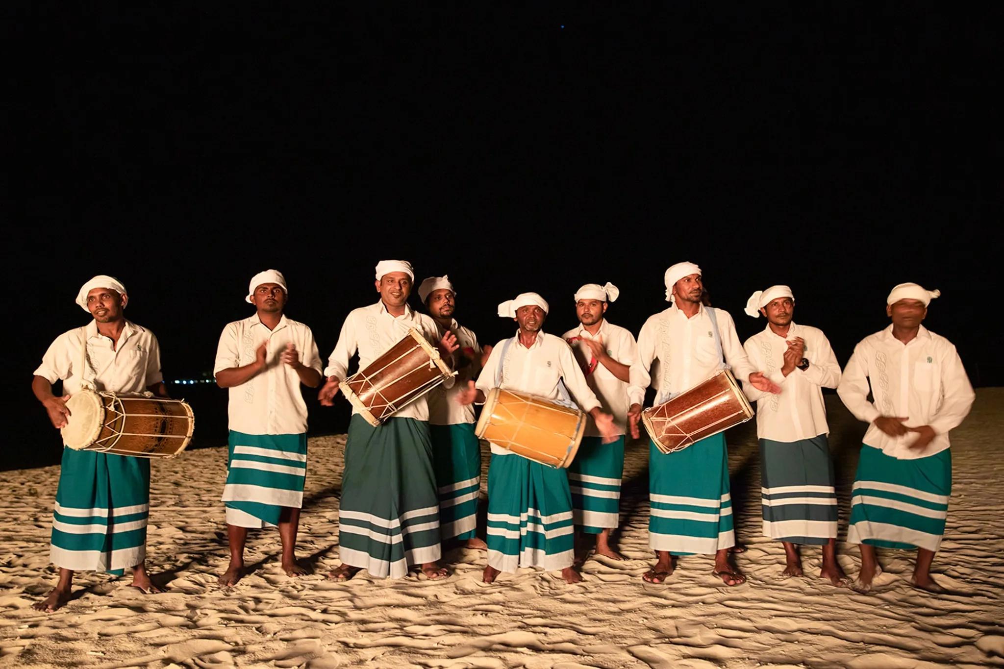 Guests learning traditional Maldivian Boduberu drumming at Angsana Velavaru