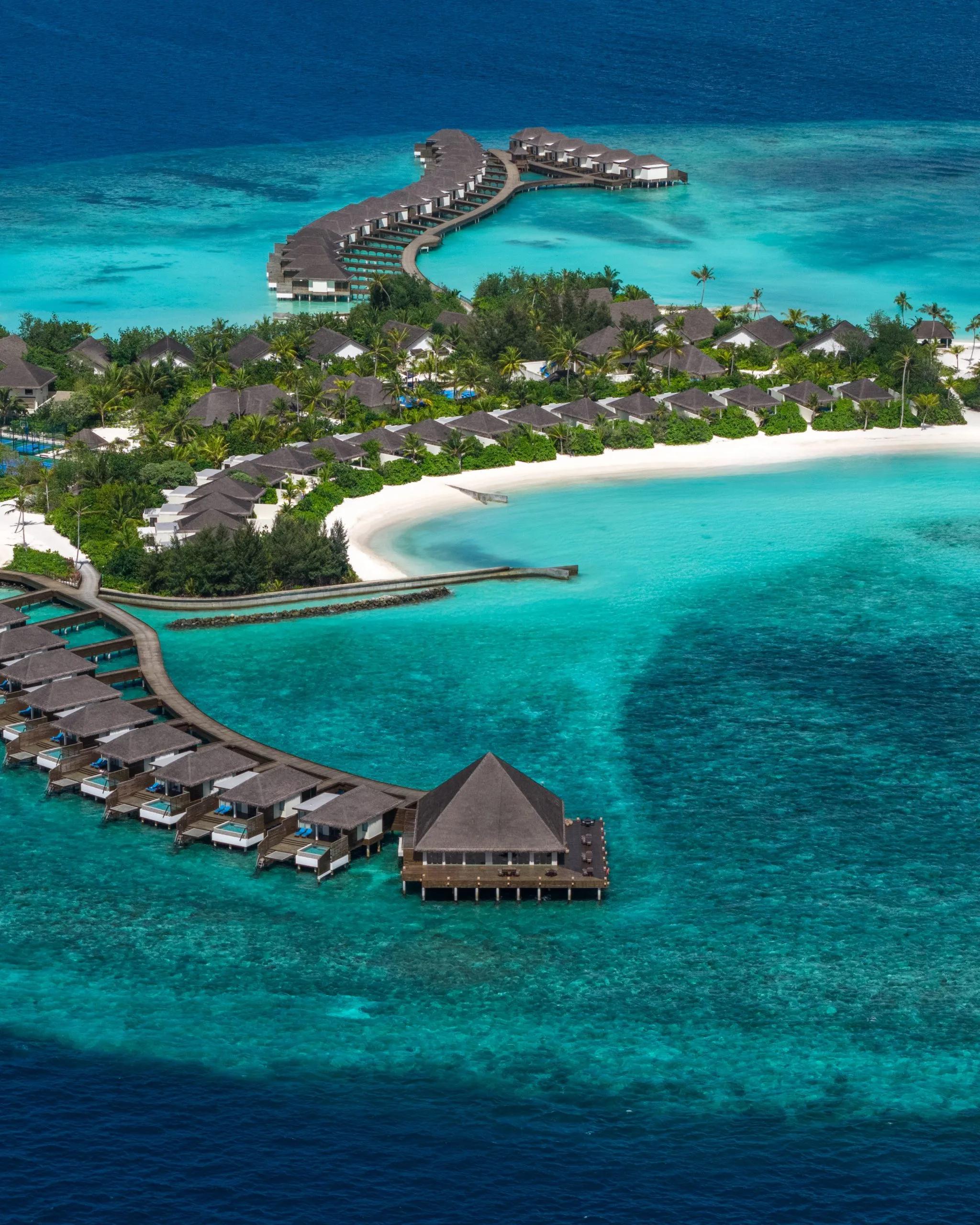 An aerial view of dusitD2 Feydhoo Maldives' lagoon and lagoon-facing villas