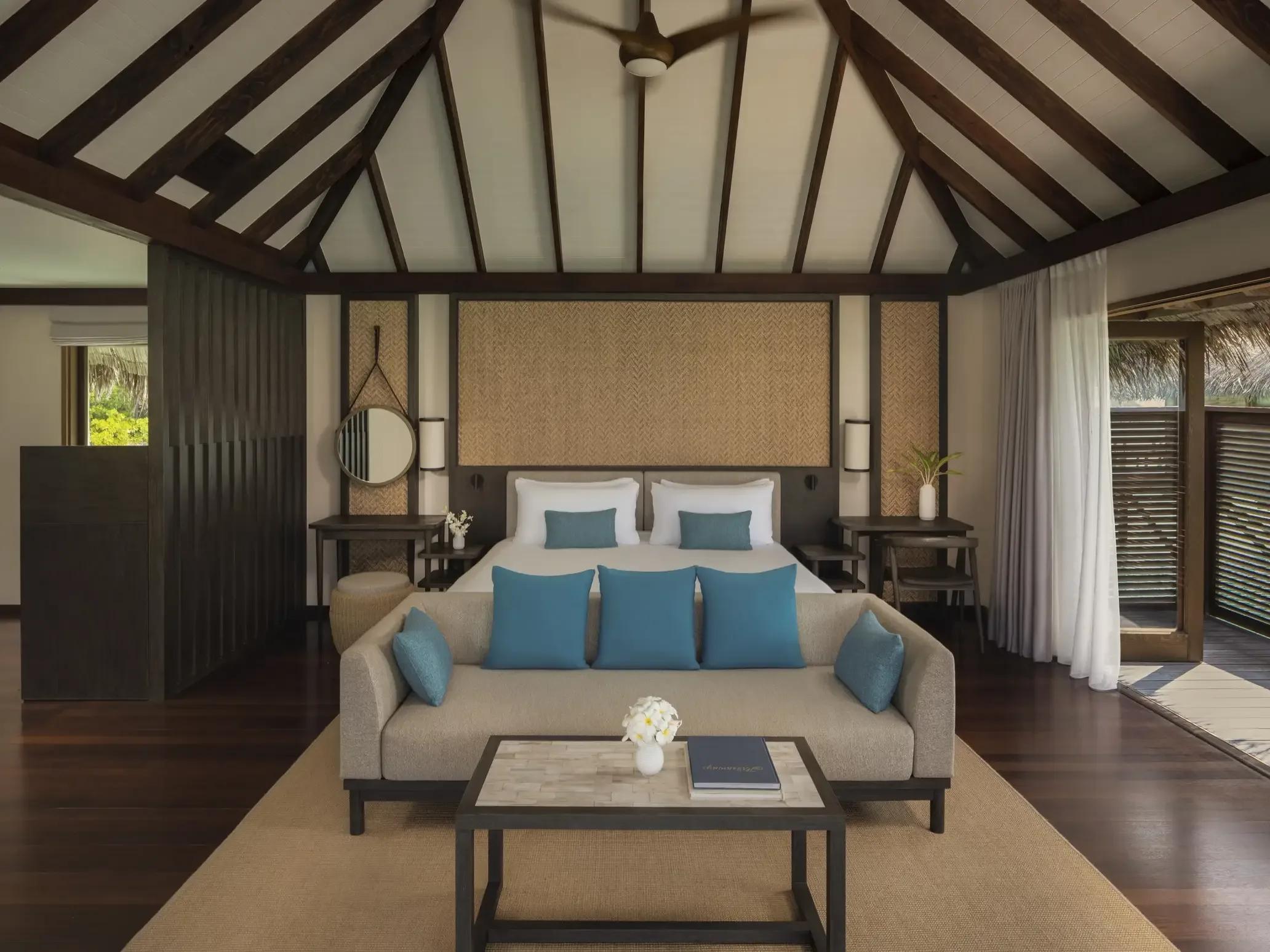 The glass-floored living room of a Deluxe Water Villa with Pool at Conrad Maldives Rangali, ocean visible below