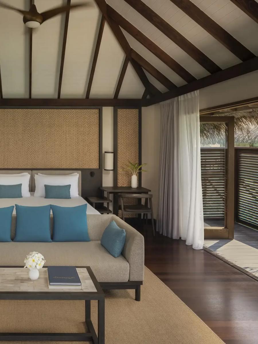 The glass-floored living room of a Deluxe Water Villa with Pool at Conrad Maldives Rangali, ocean visible below