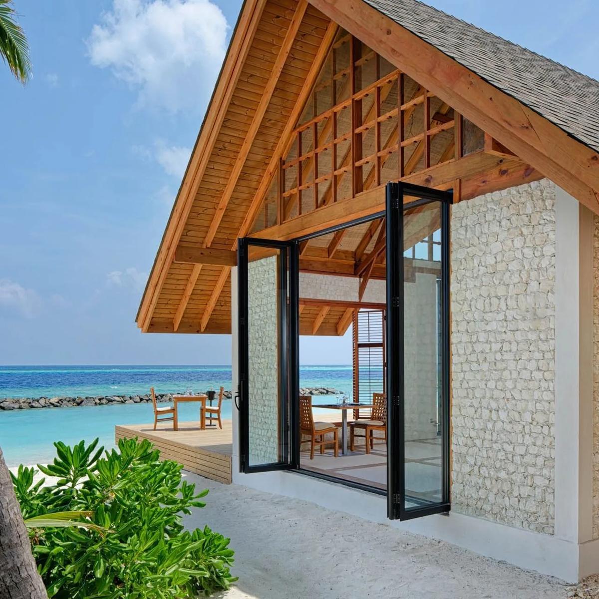 Asian Food Street's stone pavilion, folding glass doors open to the beach