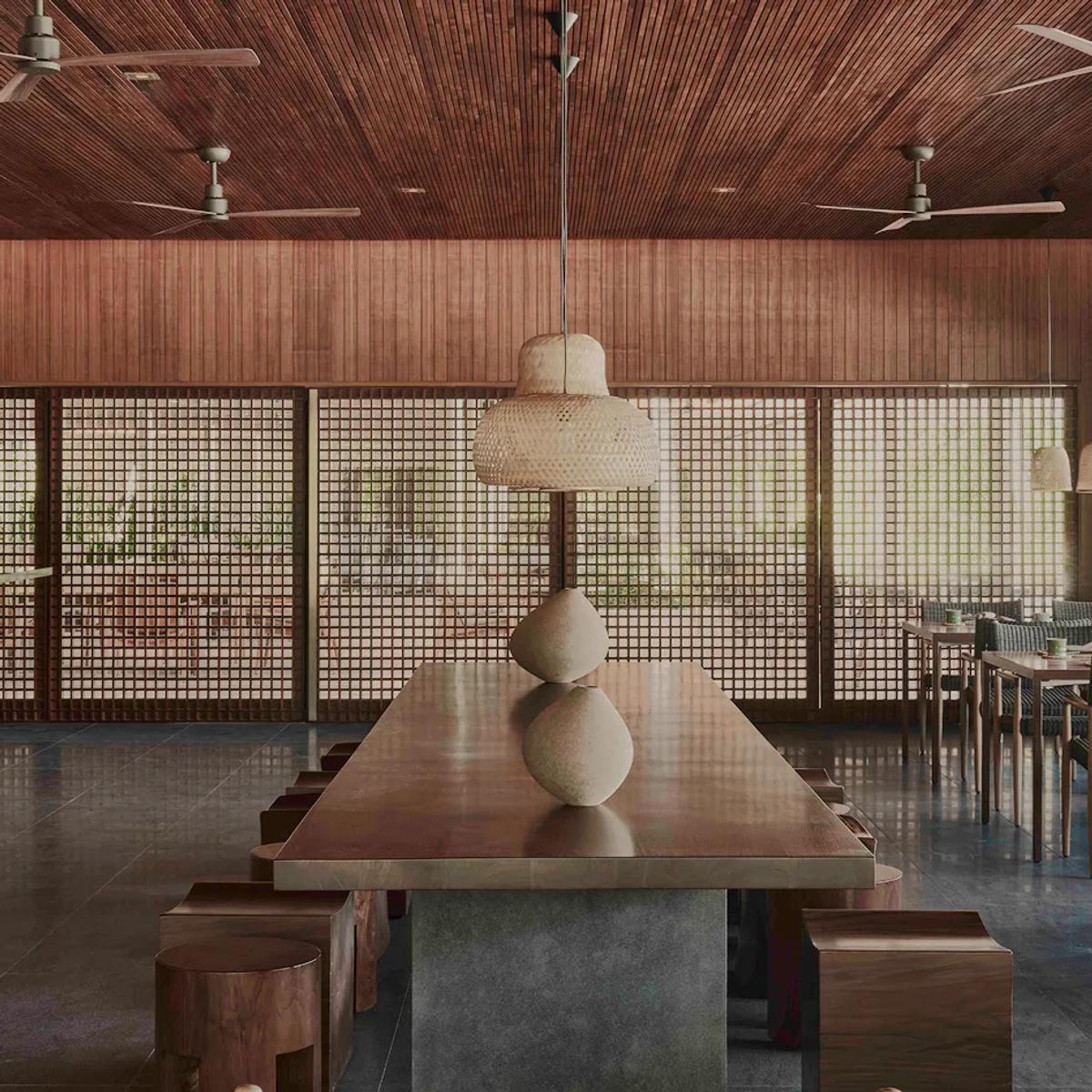 The dining room at Wok Society, wood-panelled and screened from the garden by latticed doors