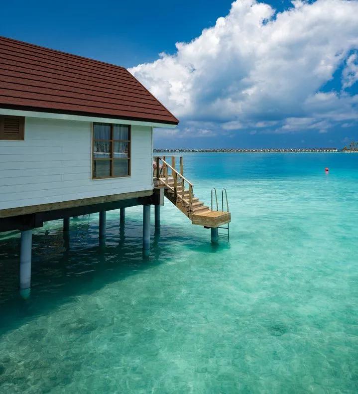 A Nest Water Villa at OBLU SELECT Lobigili, overwater with a private staircase down into the lagoon