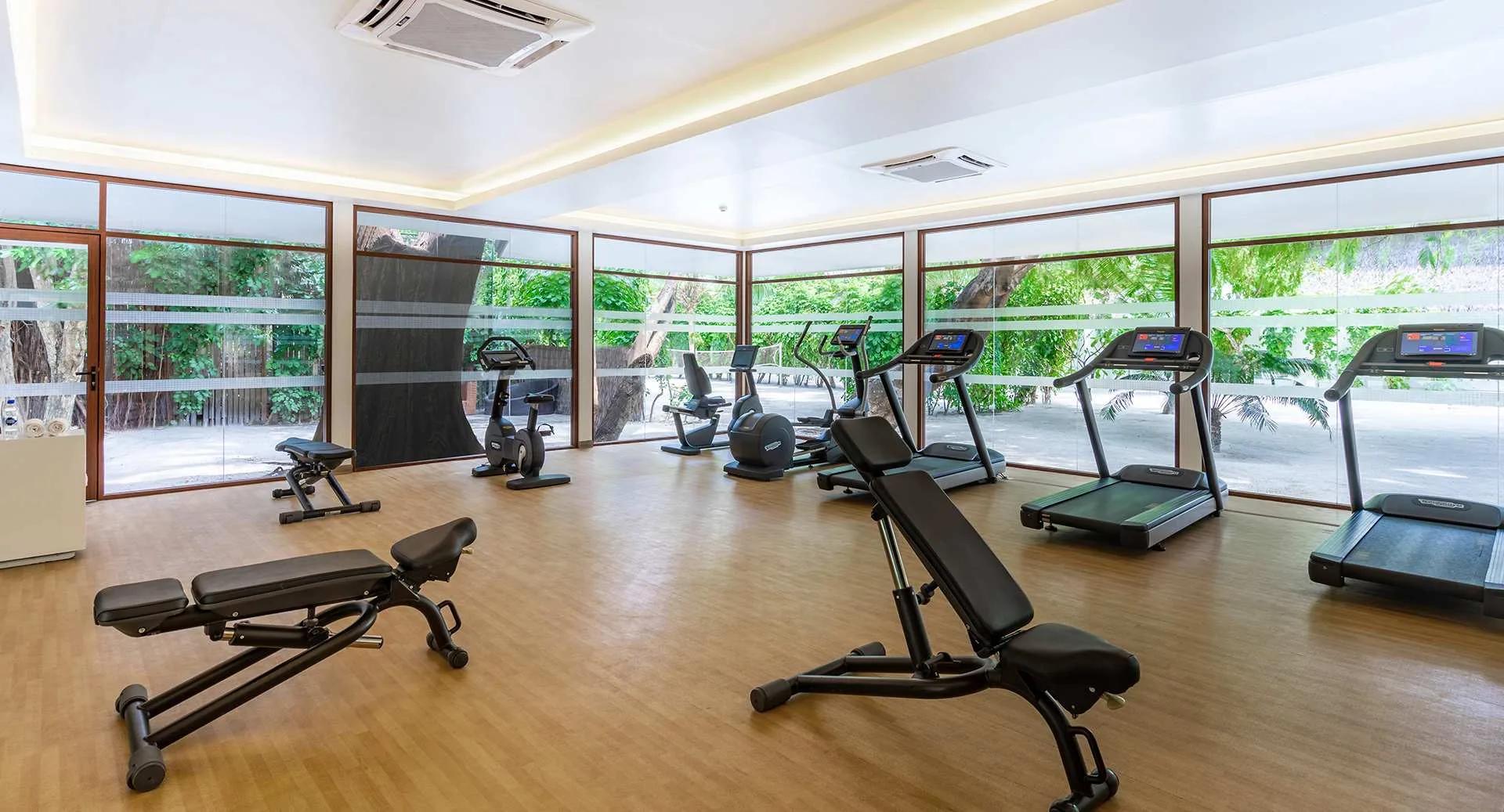 The resort's fitness centre, glass-walled and looking out onto the island's greenery