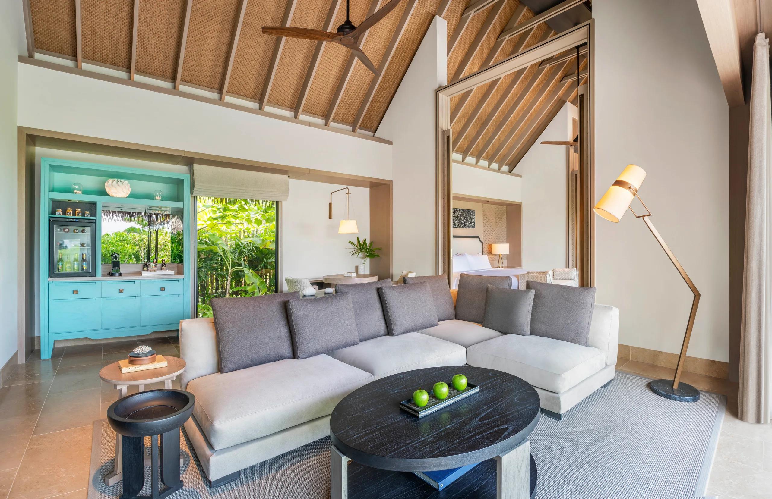The living area of a Grand Beach Villa at Waldorf Astoria Maldives Ithaafushi, opening toward the beach