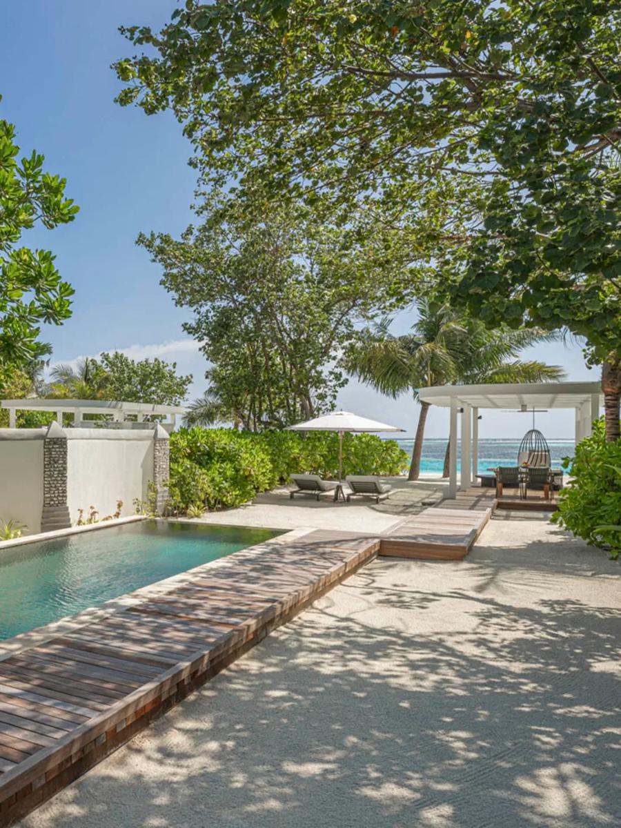 A Sunrise Family Beach Villa's pool and walkway to the beach in morning light