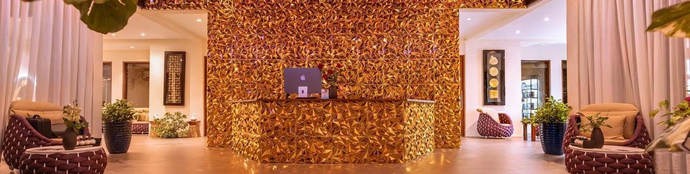 The gold-tiled reception at Essens Wellness and Spa