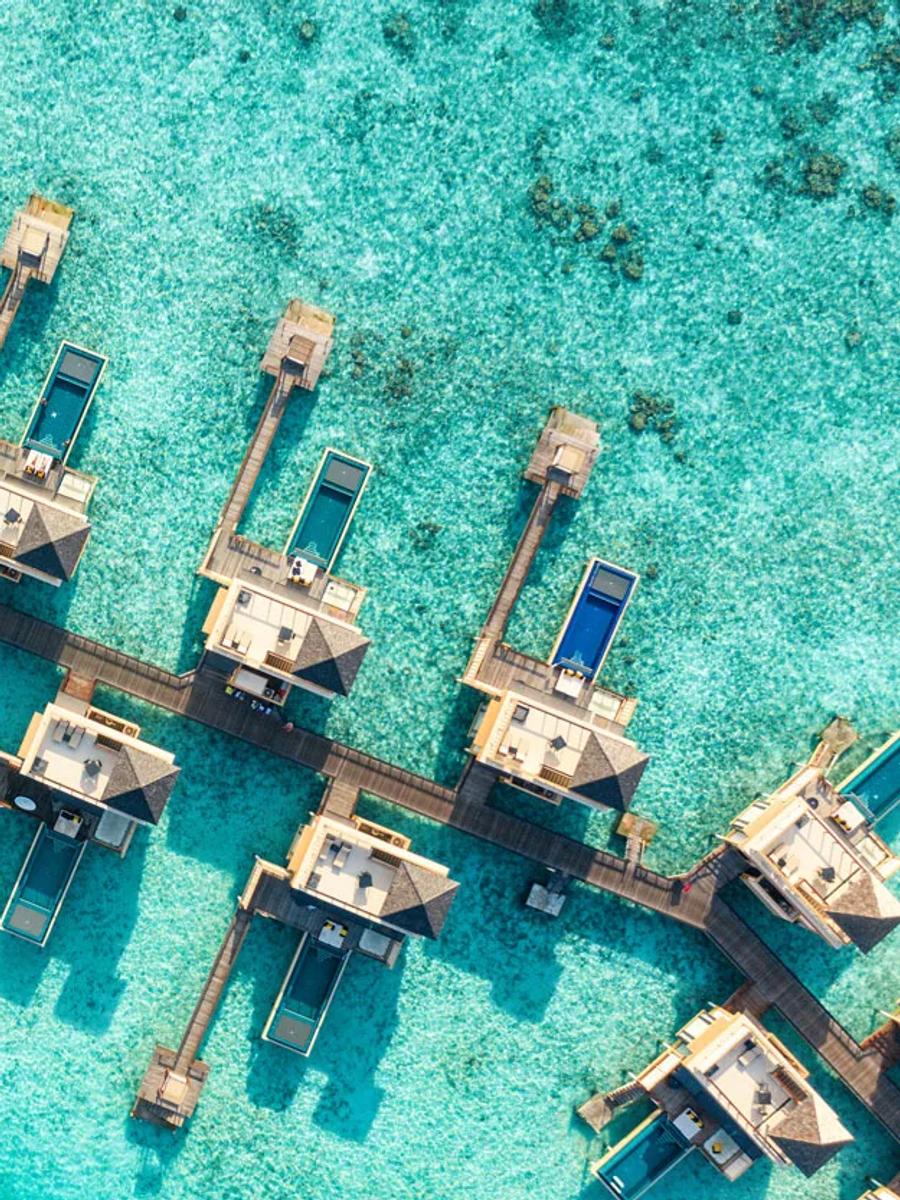 Aerial view of In-Ocean Pool Villas reaching out over the lagoon at Angsana Velavaru
