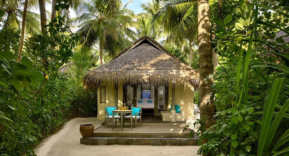 Exterior of a Sunrise Beach Villa at Anantara Dhigu, set among palm trees on the beachfront