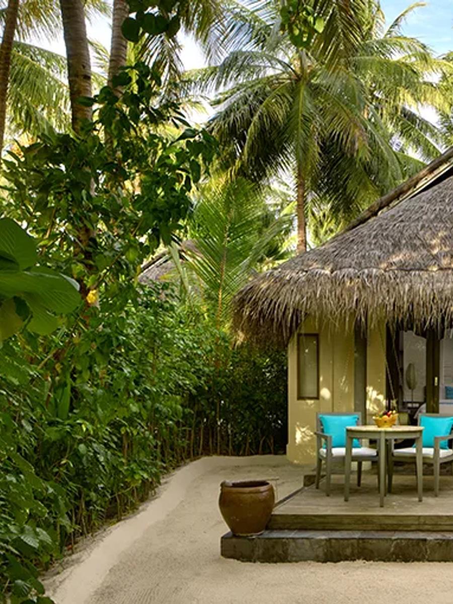 Exterior of a Sunrise Beach Villa at Anantara Dhigu, set among palm trees on the beachfront